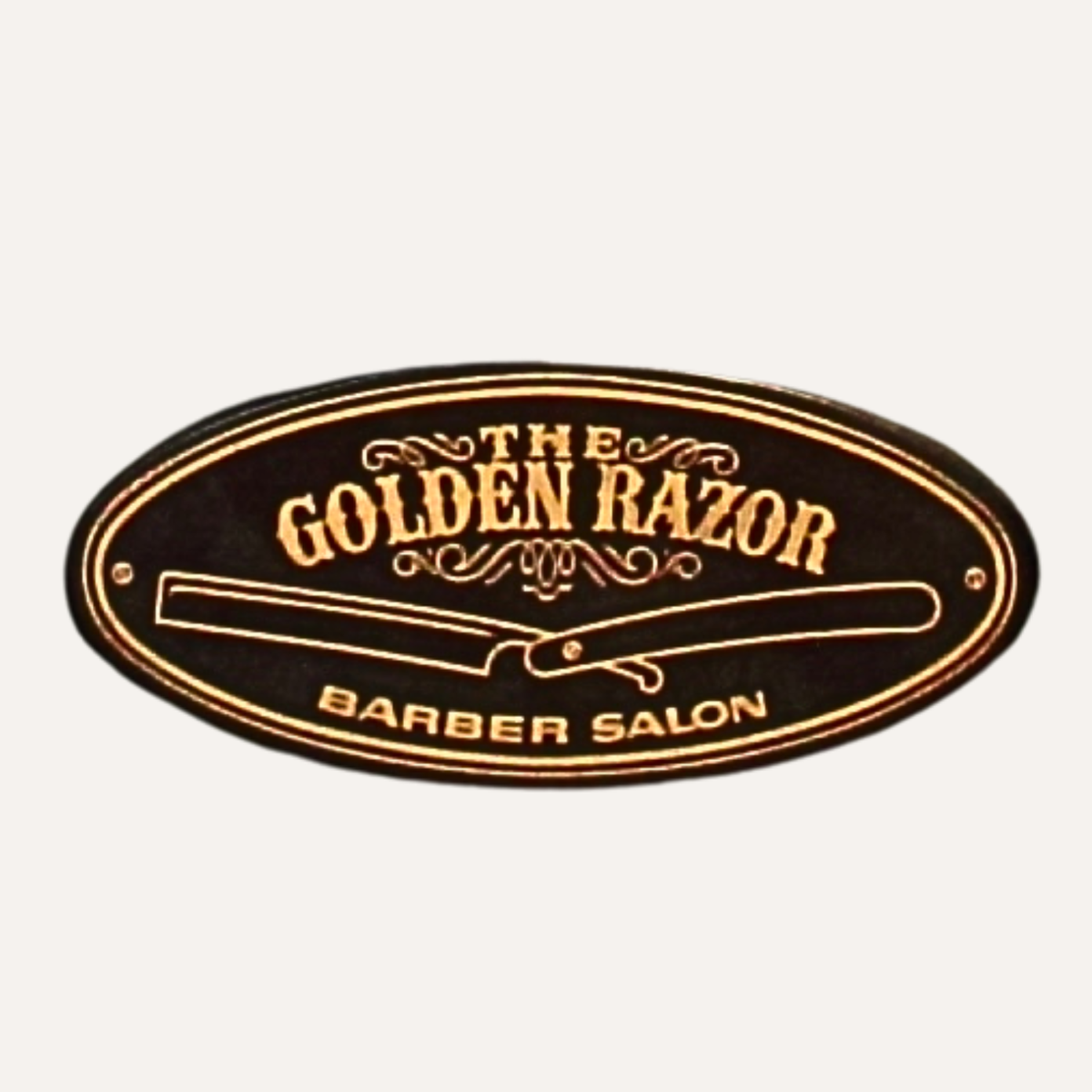 The Golden Razor Barber Salon sign, gold leaf on dark with a straight razor