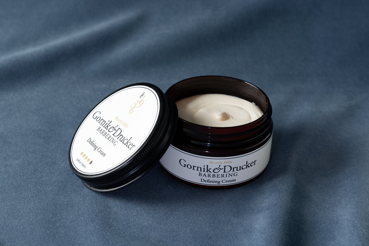 Defining Cream jar open beside its lid