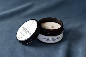 Defining Cream jar open beside its lid