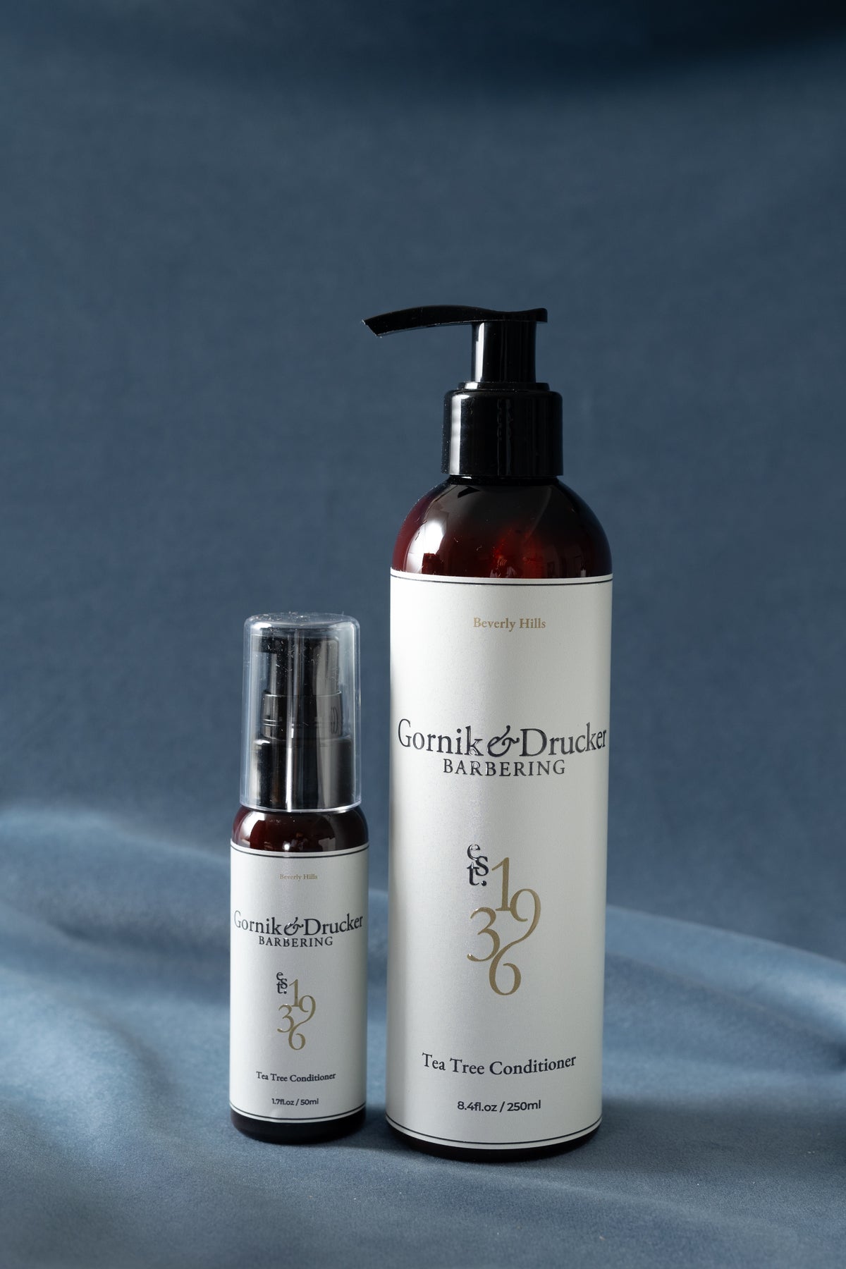 Tea Tree Conditioner in the 8oz bottle and the travel size, side by side