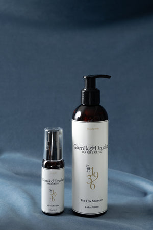 Tea Tree Shampoo in the 8oz bottle and the travel size, side by side